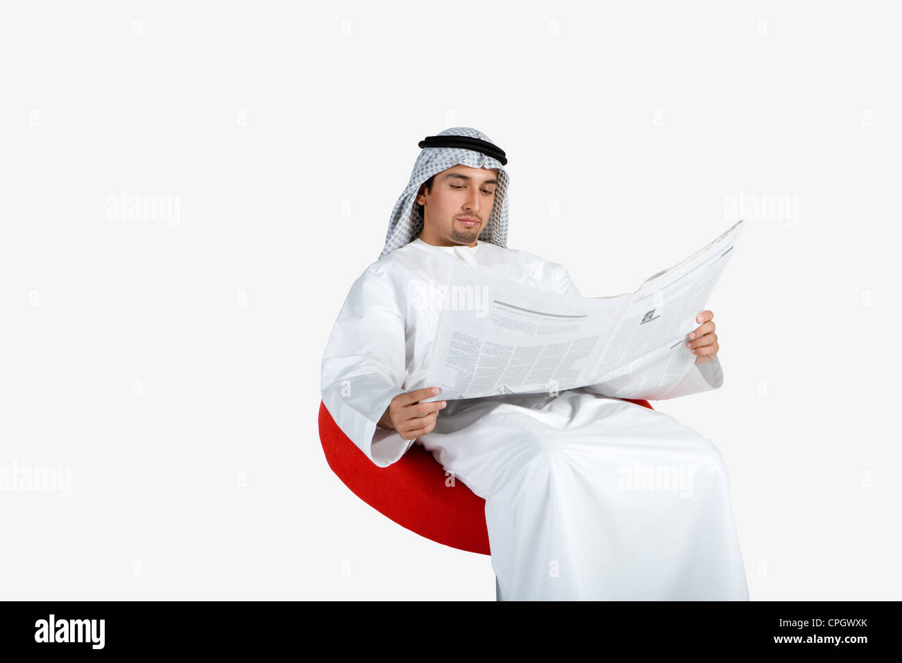 Young man reading newspaper Stock Photo