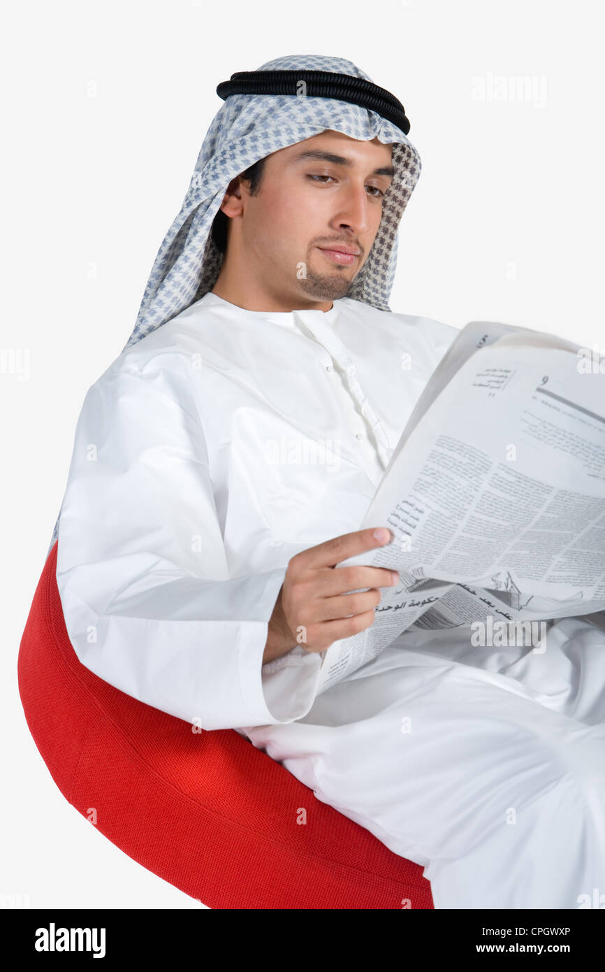 Young man reading newspaper Stock Photo - Alamy