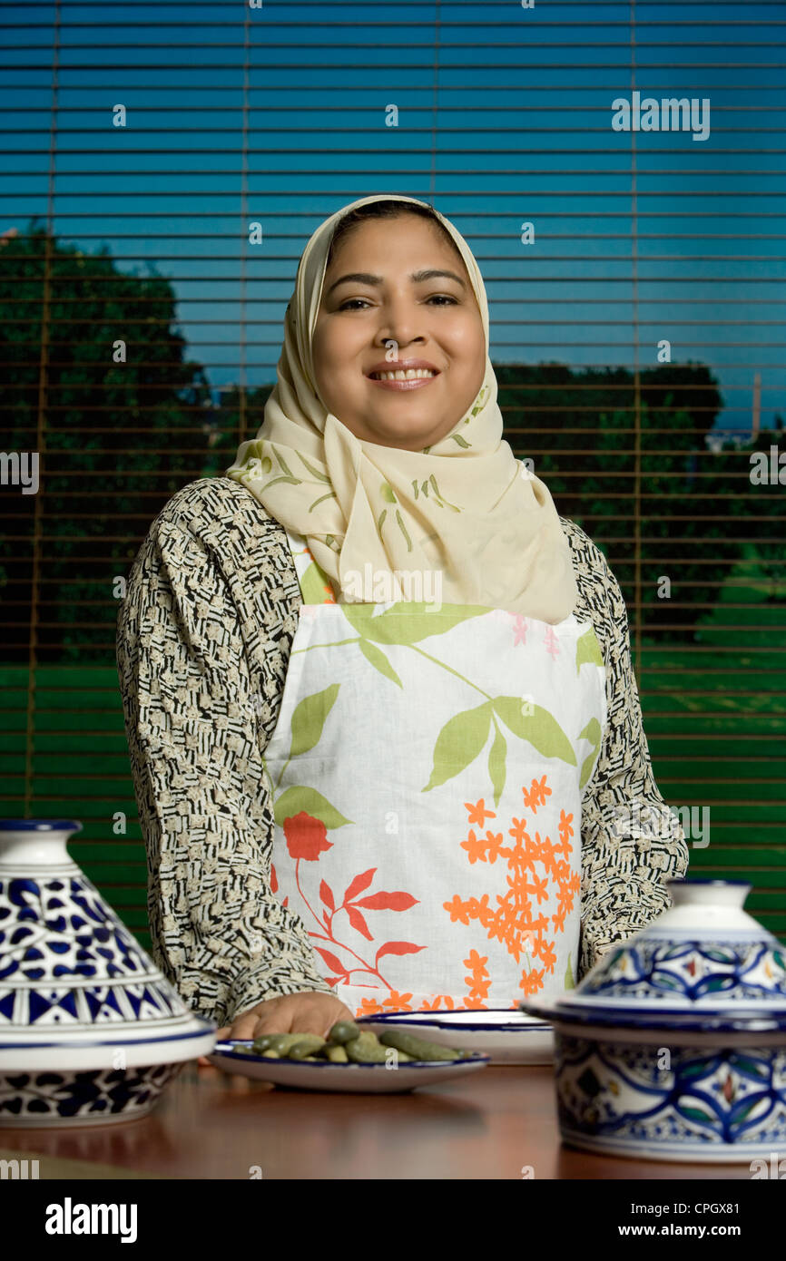 Mid adult woman with crockery in foreground, portrait Stock Photo Alamy