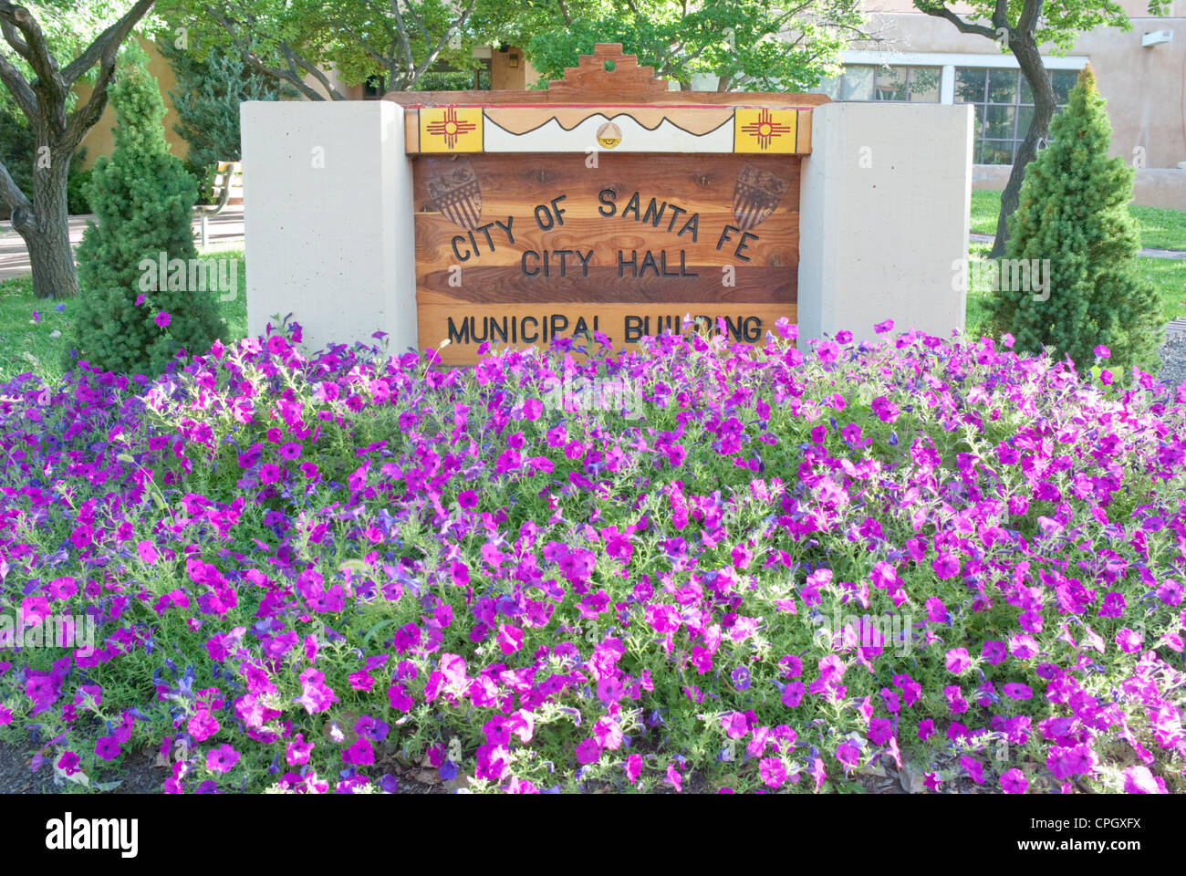Pink petunias obliterate the City Hall sign in Santa Fe. Stock Photo