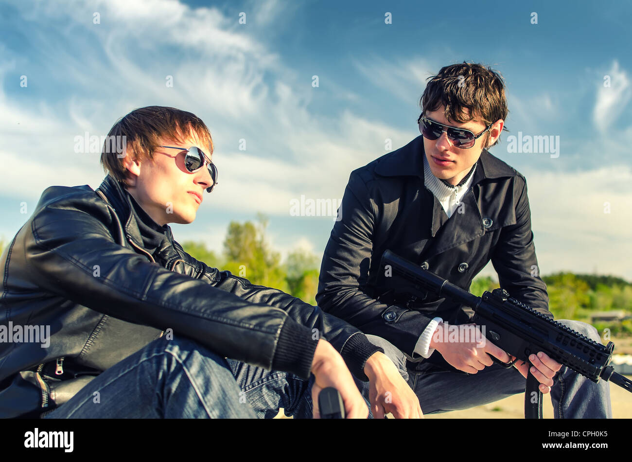 Portrait of two tough guys with guns Stock Photo