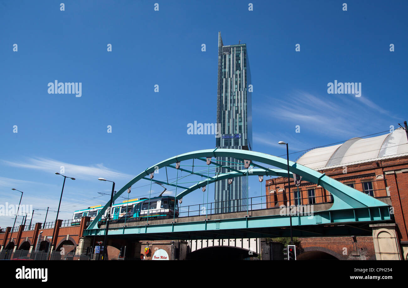 A Metrolink tram passing Manchester Central was G-Mex with Ian Simpson designed Beetham tower Hilton Hotel in view Stock Photo