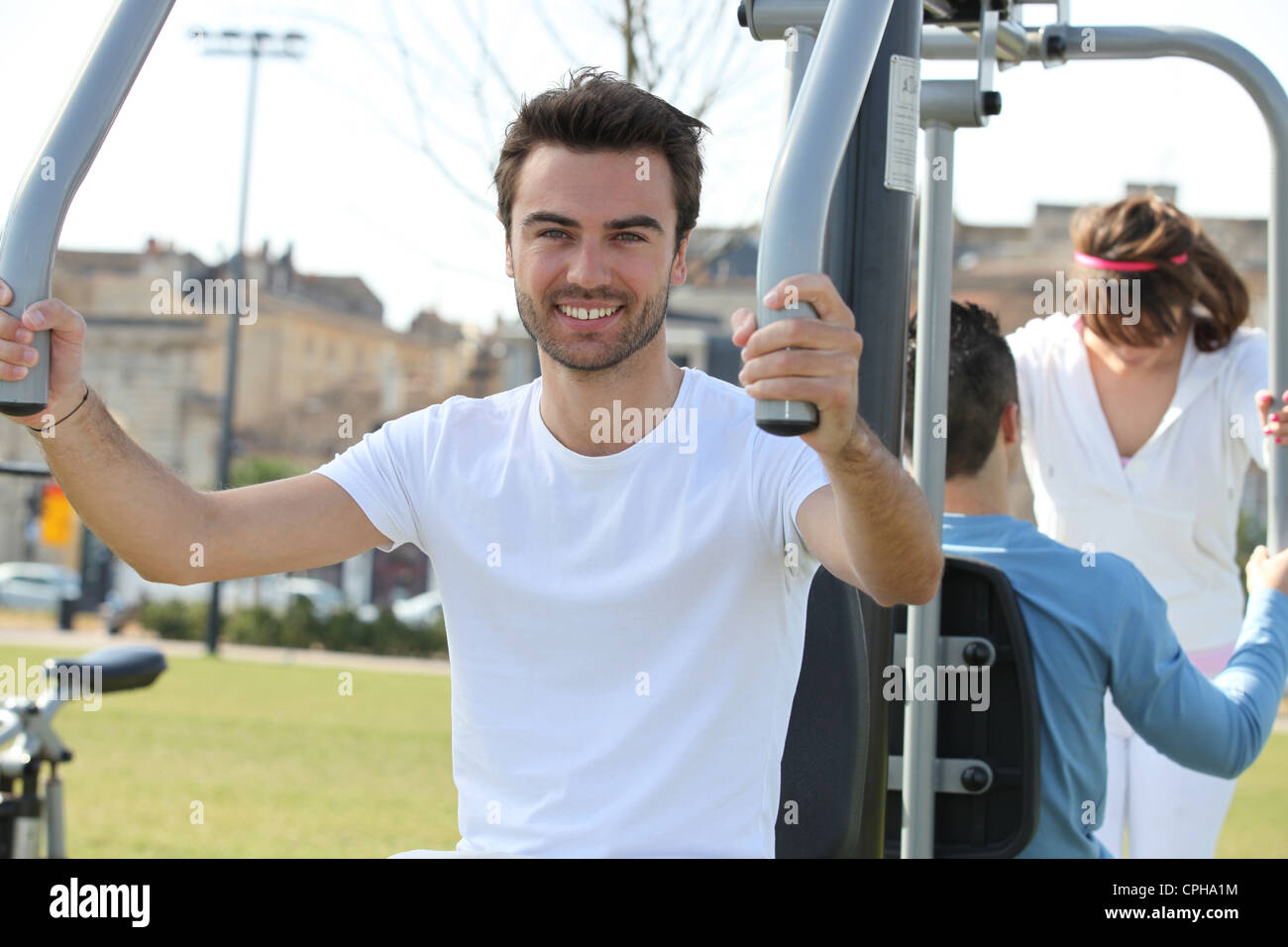 a man doing fitness with public fitness machine Stock Photo