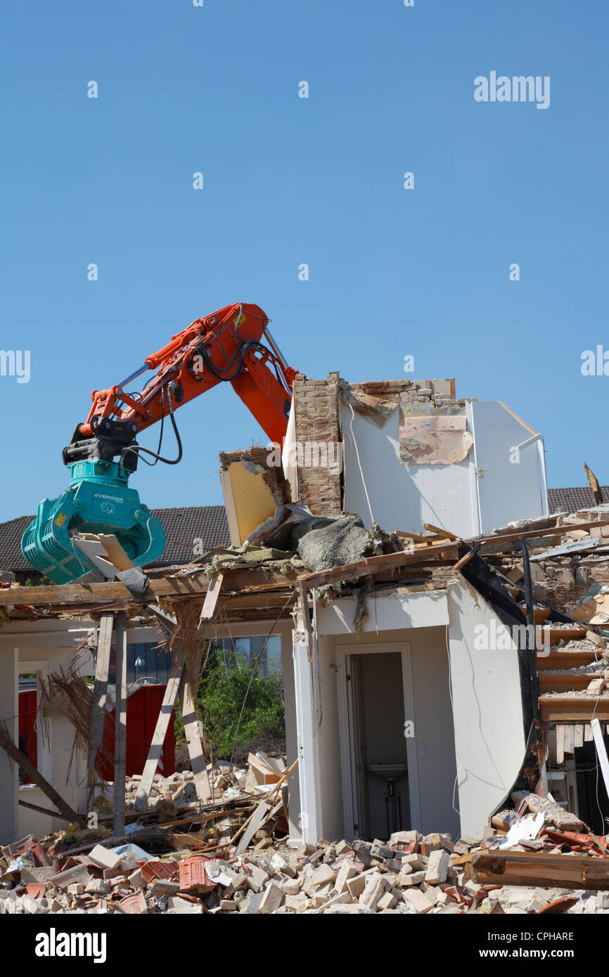 A house is demolished by use of a dredger to make space for a new supermarket, Denmark Stock Photo