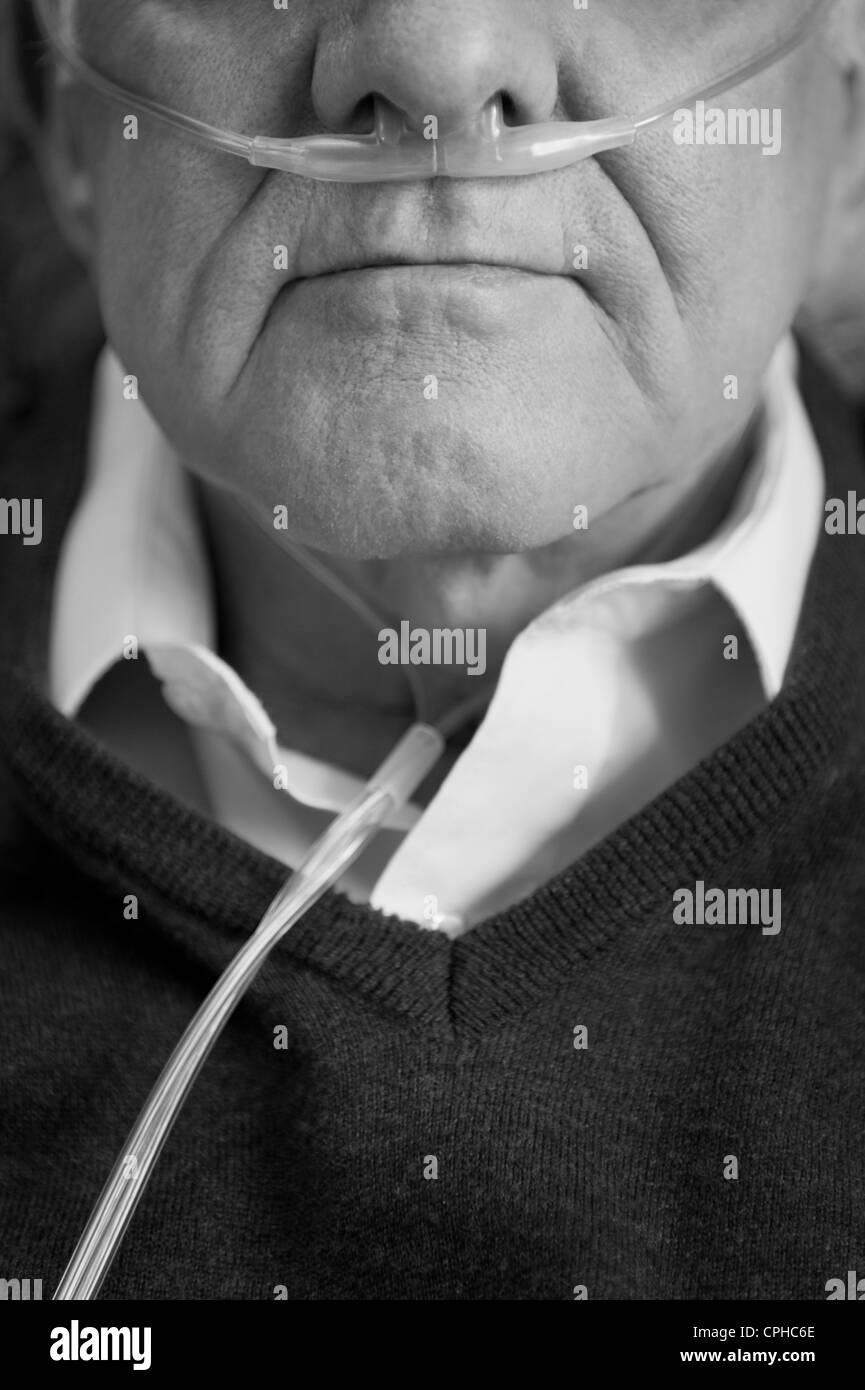 Closeup black and white portrait of an elderly man wearing oxygen nasal tube Stock Photo