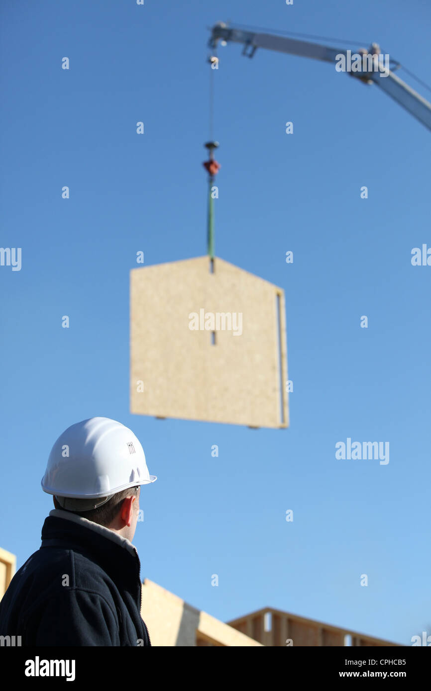 Crane lifting whole wooden wall Stock Photo Alamy