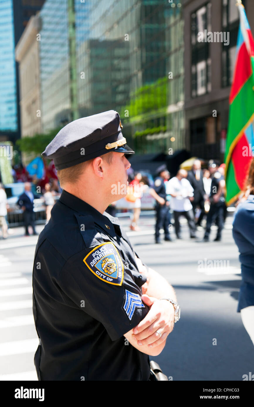 close detail of NYPD police officer and badge on shoulder of uniform from side view on street of New York iconic sight Stock Photo