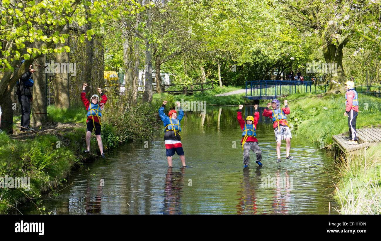 Children crossing river on rope bridge Stock Photo Alamy