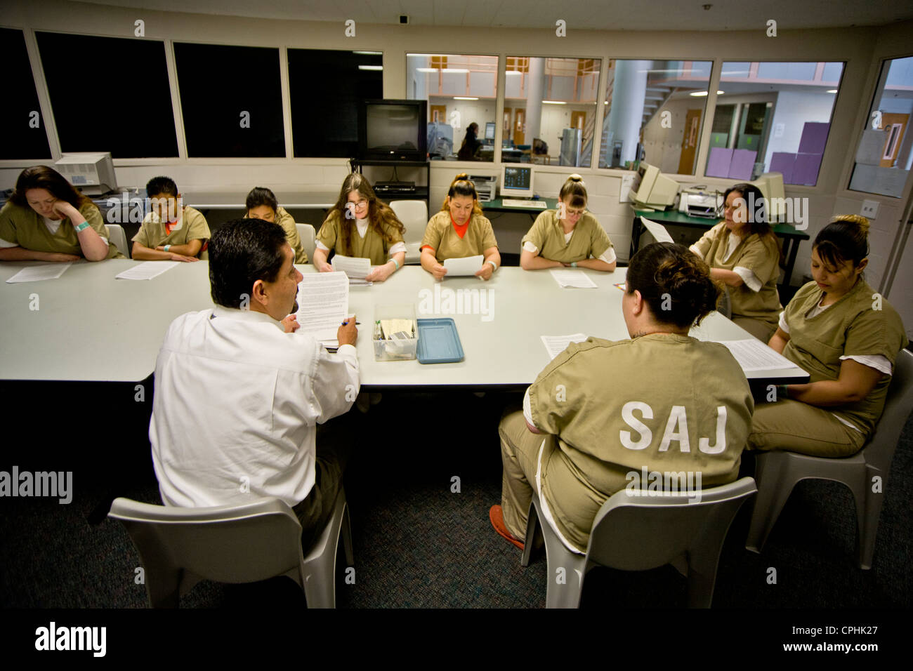 Uniformed women jail inmates participate in a drug treatment seminar with a Hispanic instructor in Santa Ana, CA Stock Photo