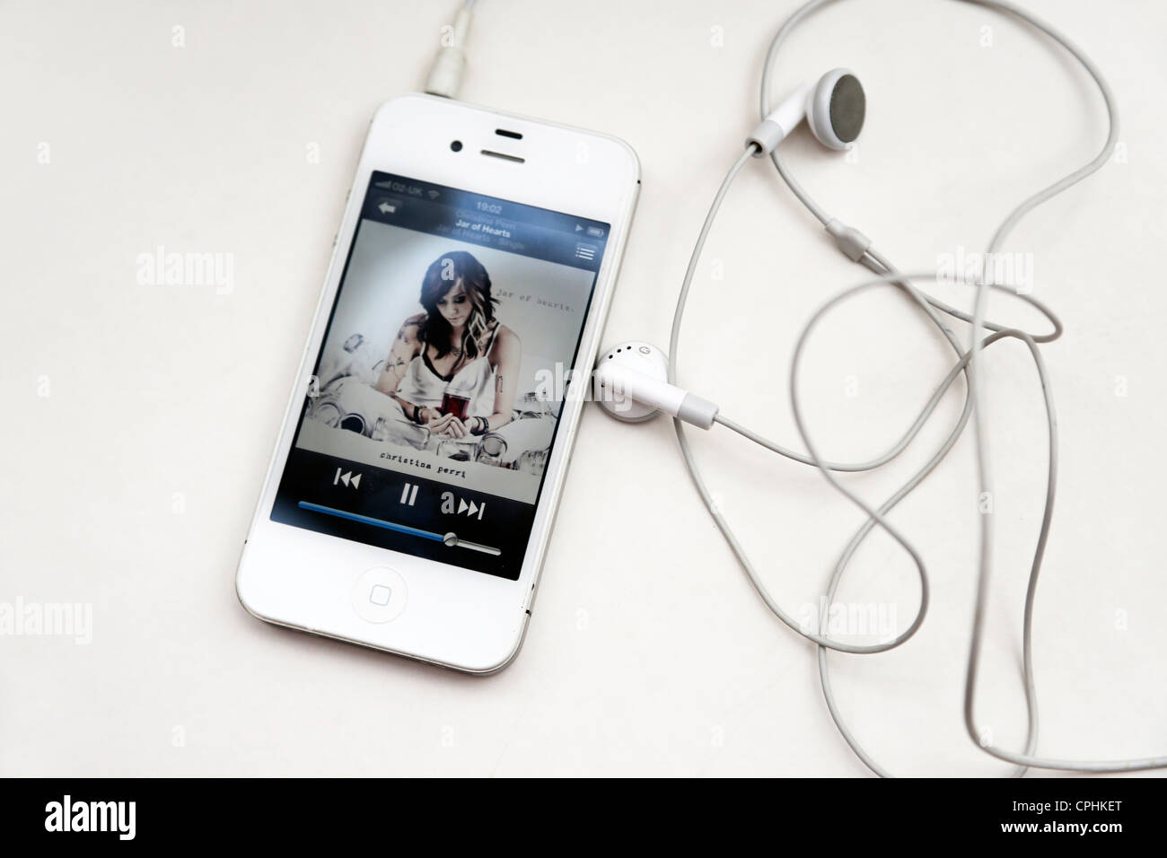 iPhone 4S With Headphones Plugged In Playing Music Stock Photo - Alamy