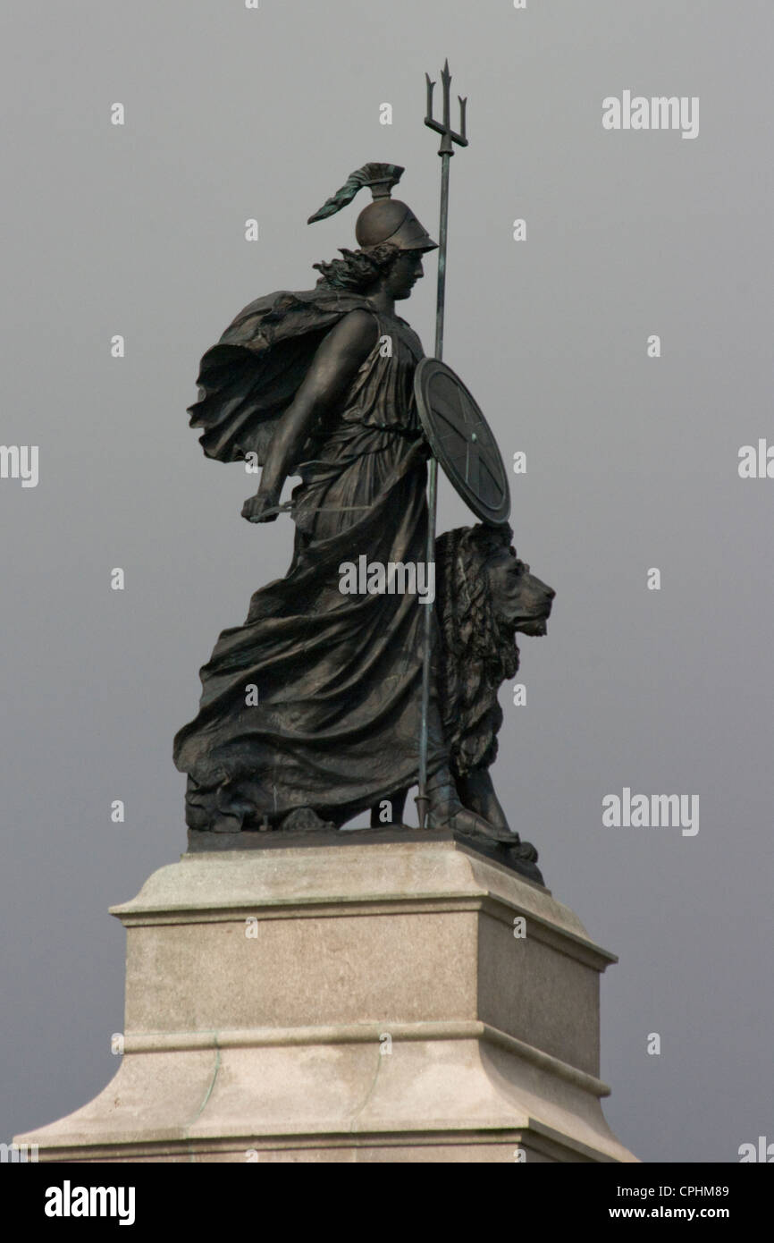 Statue of Brittania with her shield and trident and lion at her side. The Armada Memorial on Plymouth Hoe Stock Photo