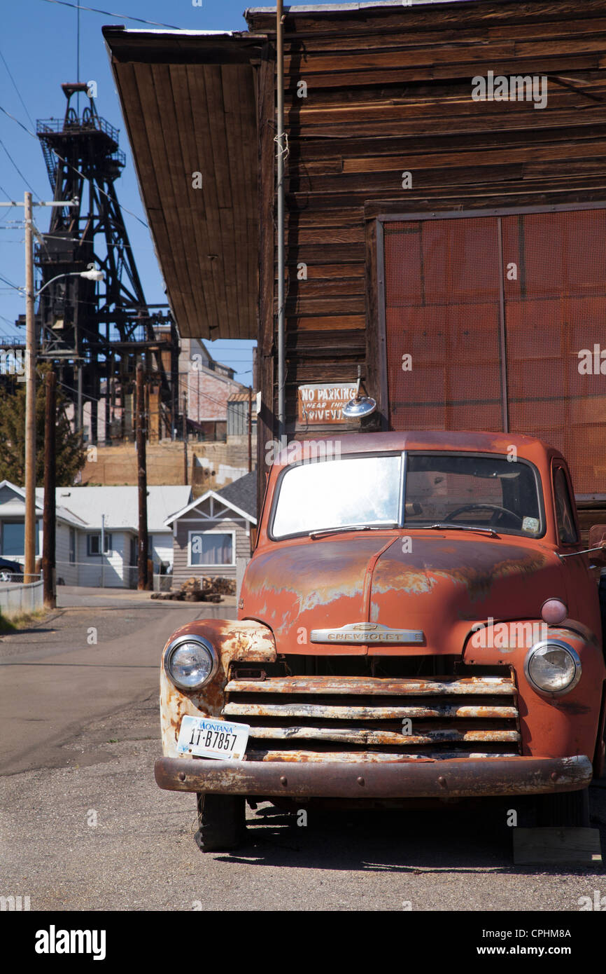Old Chevy truck, mine headframe, Butte, Montana, USA Stock Photo