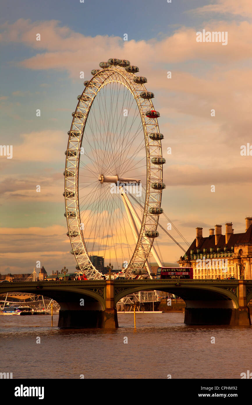 London Eye, Millennium wheel in late afternoon light with Westminster Bridge and Red bus, London, England. Stock Photo
