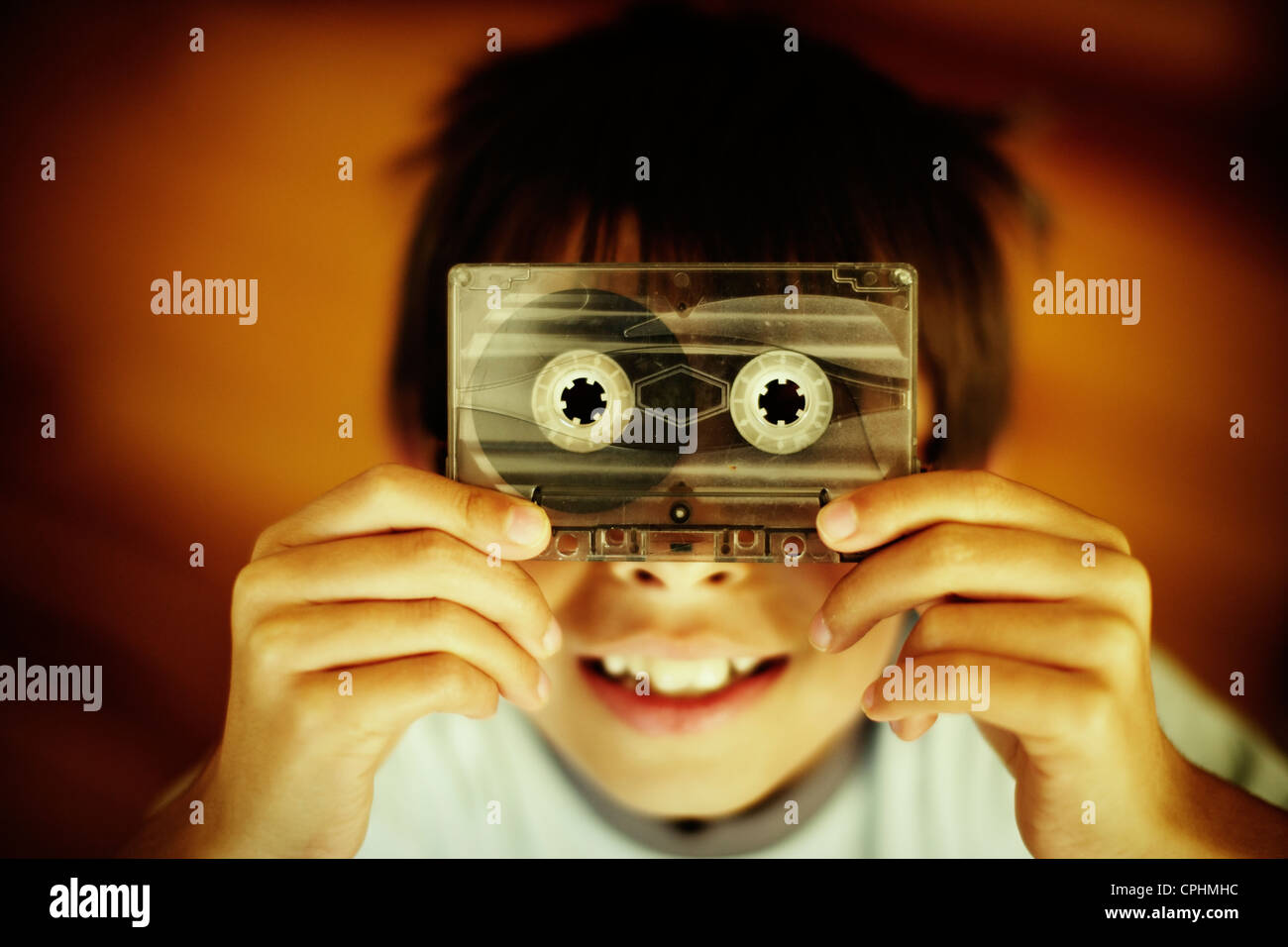 Boy holds old casette tape. Stock Photo