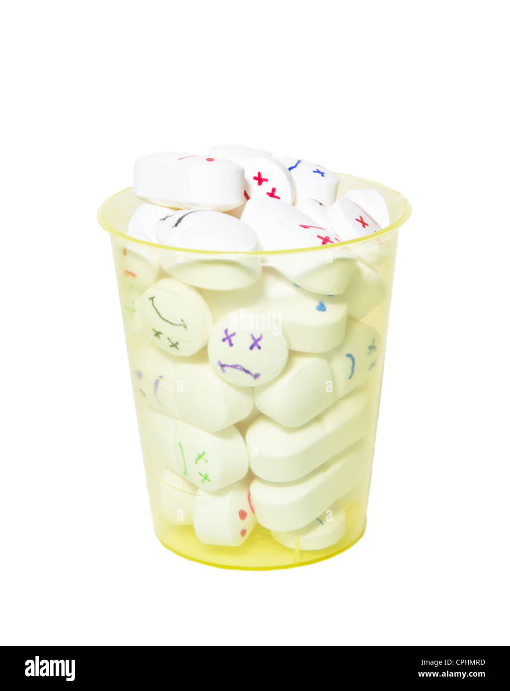 smiley face pills in a cup Stock Photo