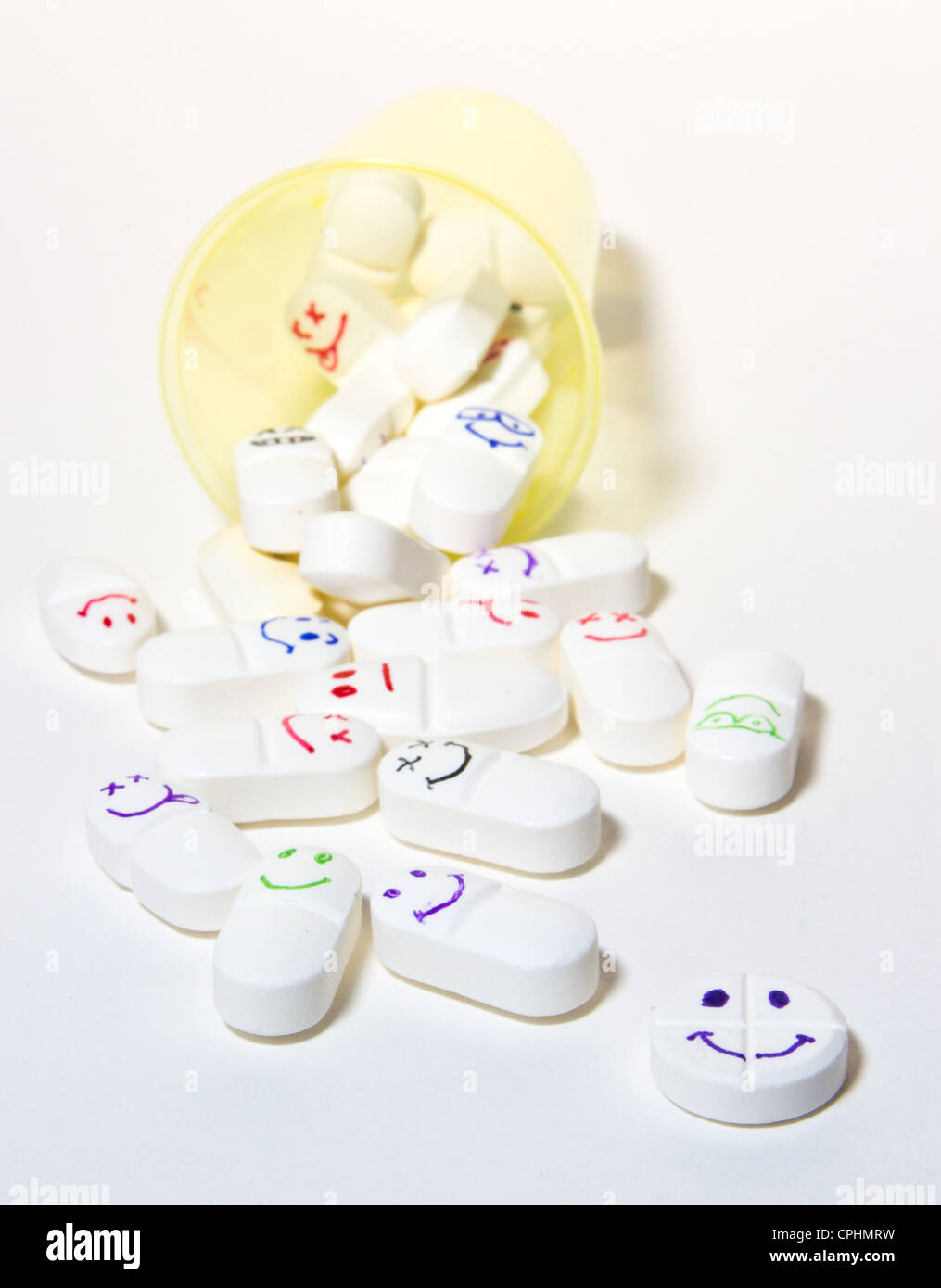 smiley face pills in a cup Stock Photo