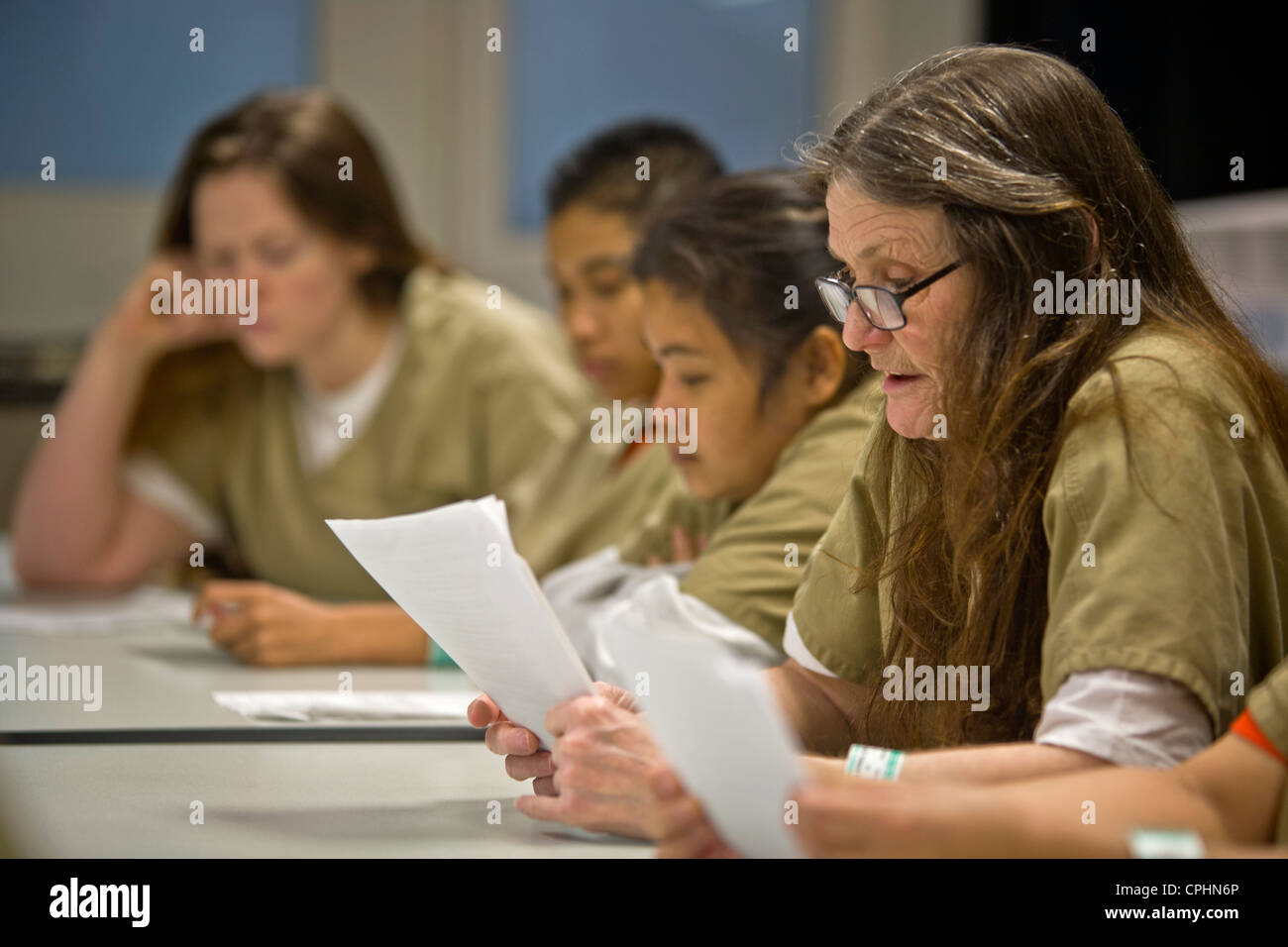 Uniformed women jail inmates participate in a drug treatment seminar in Santa Ana, CA. Note variety of ages and races Stock Photo