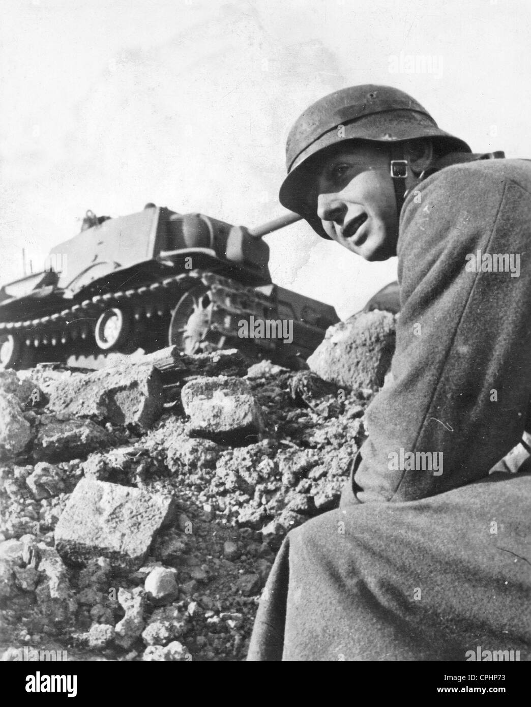 German Soldier in Front of a Destroyed Russian Tank, 1941 Stock Photo