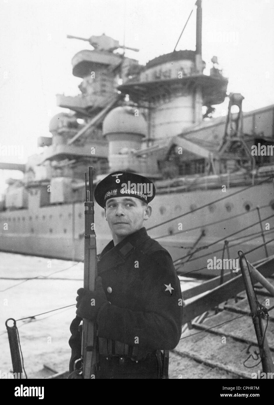 Sailor in Front of the Battleship 'Scharnhorst,' 1939 Stock Photo