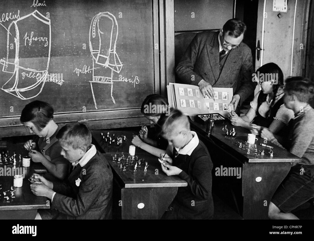 Pupils painting toy soldiers, 1933 Stock Photo