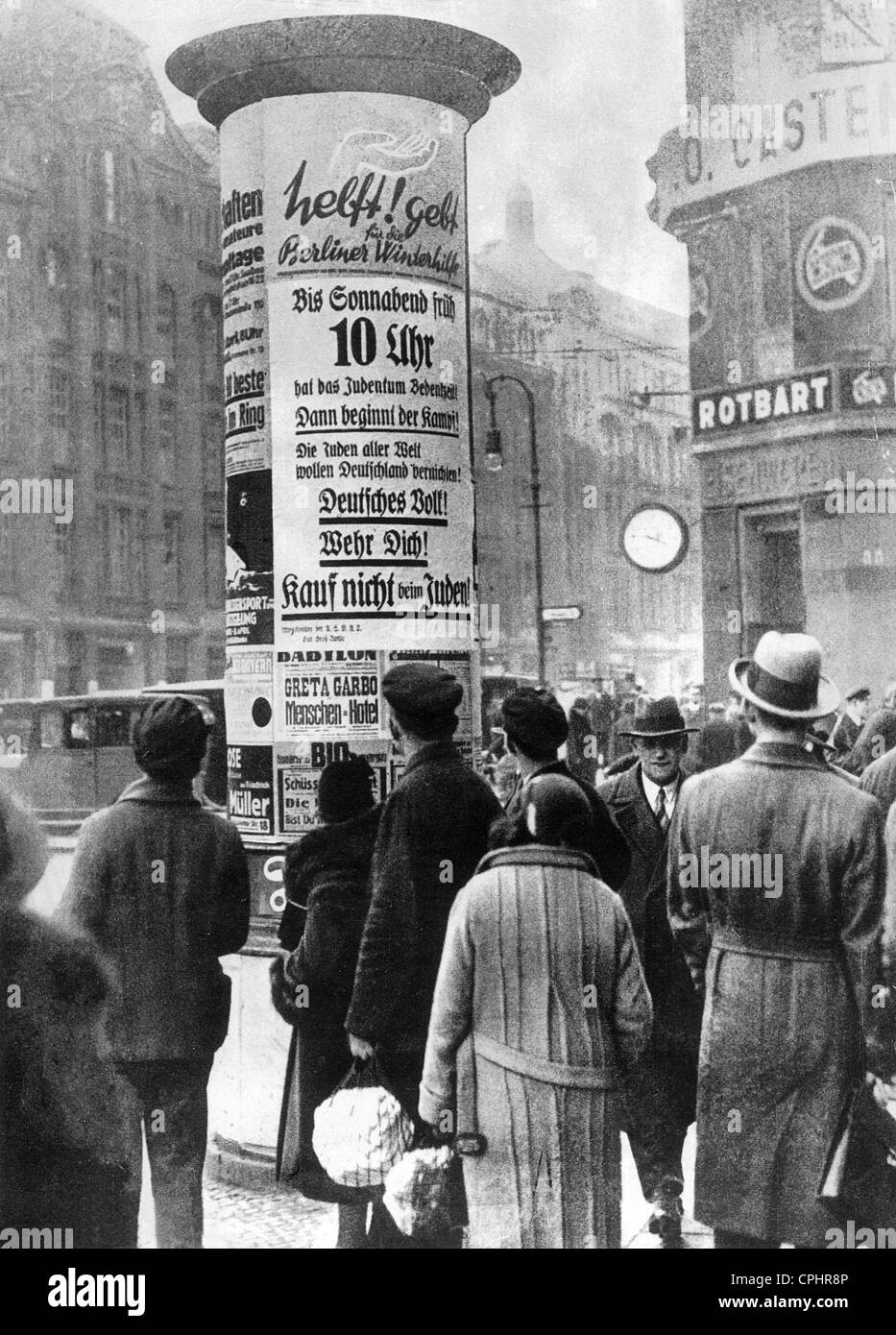 Anti-semitic posters on an advertising column in Berlin, 1933 (b/w photo) Stock Photo