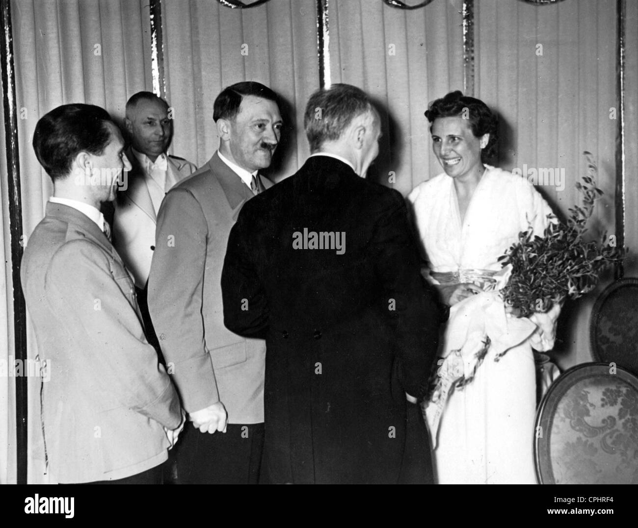 Adolf Hitler and party meeting Leni Riefenstahl during a break between showings at the premiere of 'Olympia' at the UFA-Palast, Stock Photo