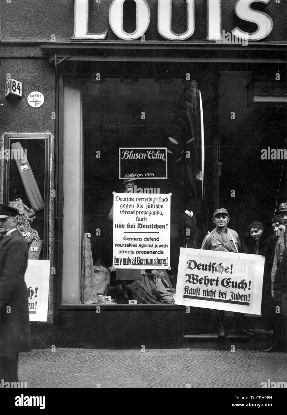 SA men stand guard outside a Jewish-owned clothing store, encouraging a public boycott, Berlin, 1933 (b/w photo) Stock Photo
