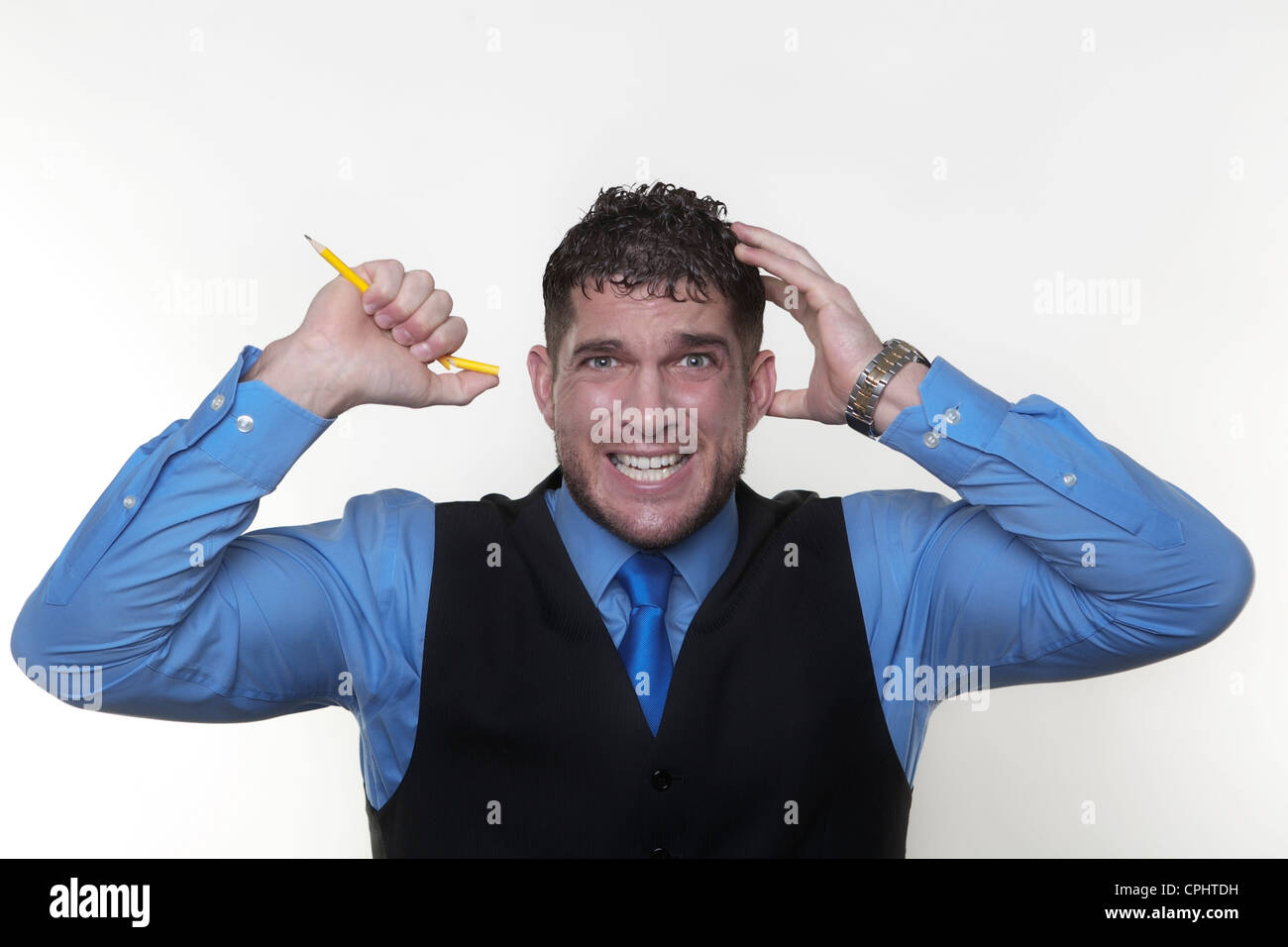 stressed out businessman breaking pencil. in need of stress management