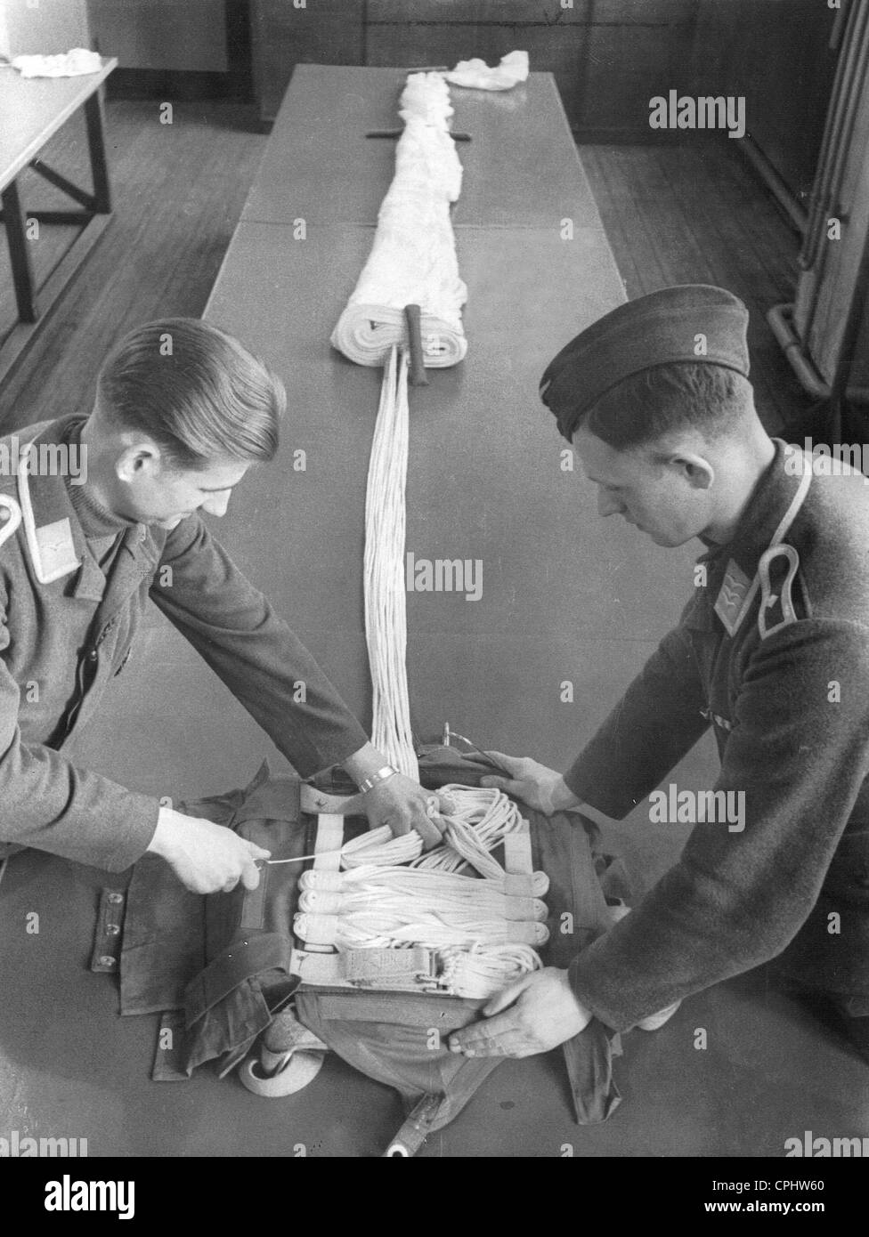 Folding up a parachute in the parachuting school in Stendal, 1936 Stock Photo