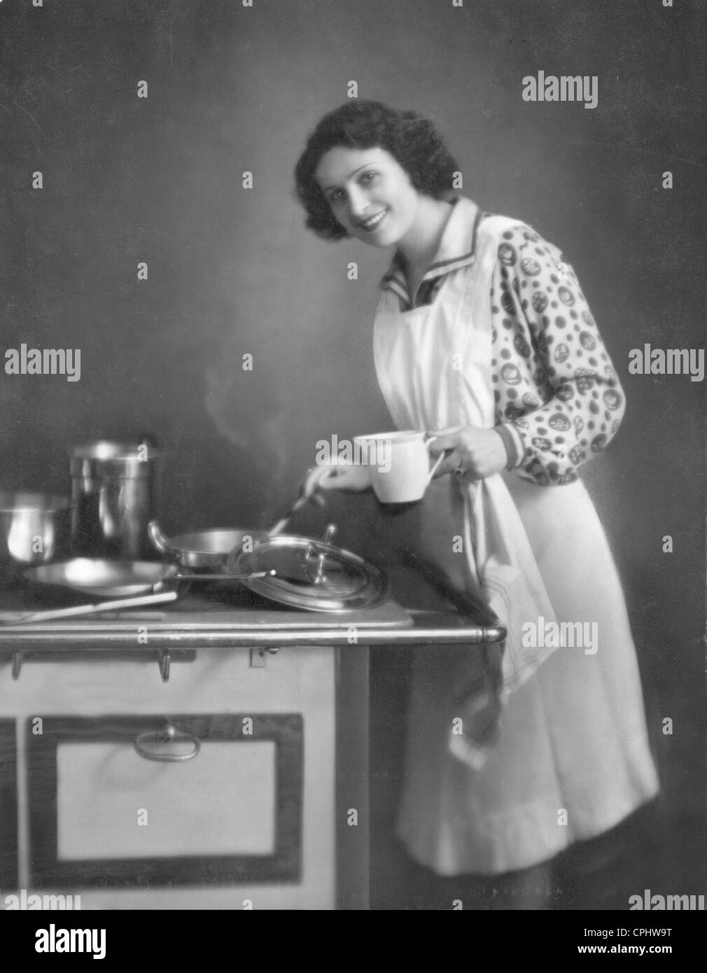 Woman in kitchen stove Black and White Stock Photos & Images - Alamy
