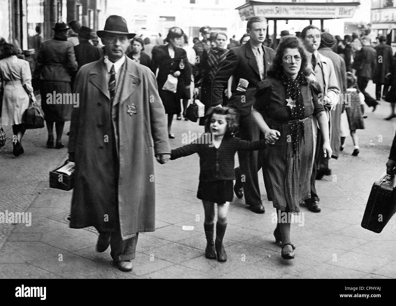 A Jewish family walking through a Berlin street wearing the Star of David on their lapels, Berlin (b/w photo) Stock Photo