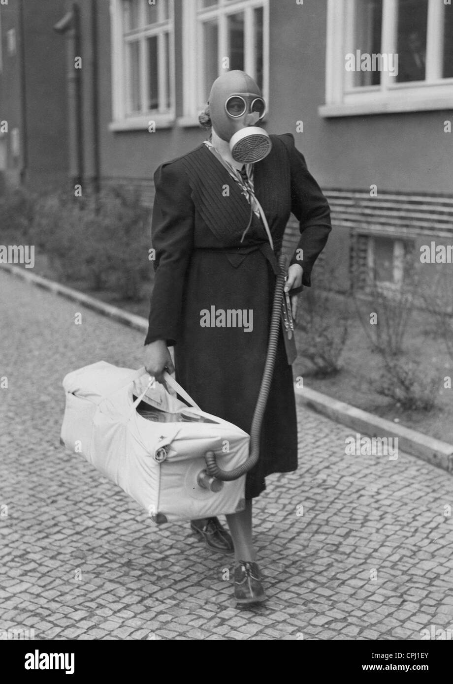 Woman with a gas protection bed gas during an air raid protection exercise, 1938 Stock Photo