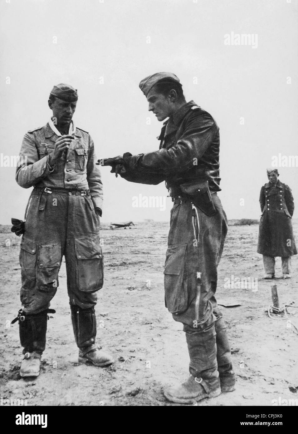 Fighter pilot Hans-Joachim Marseille (right) talks to an unknow person about his air fight in North Africa. Stock Photo