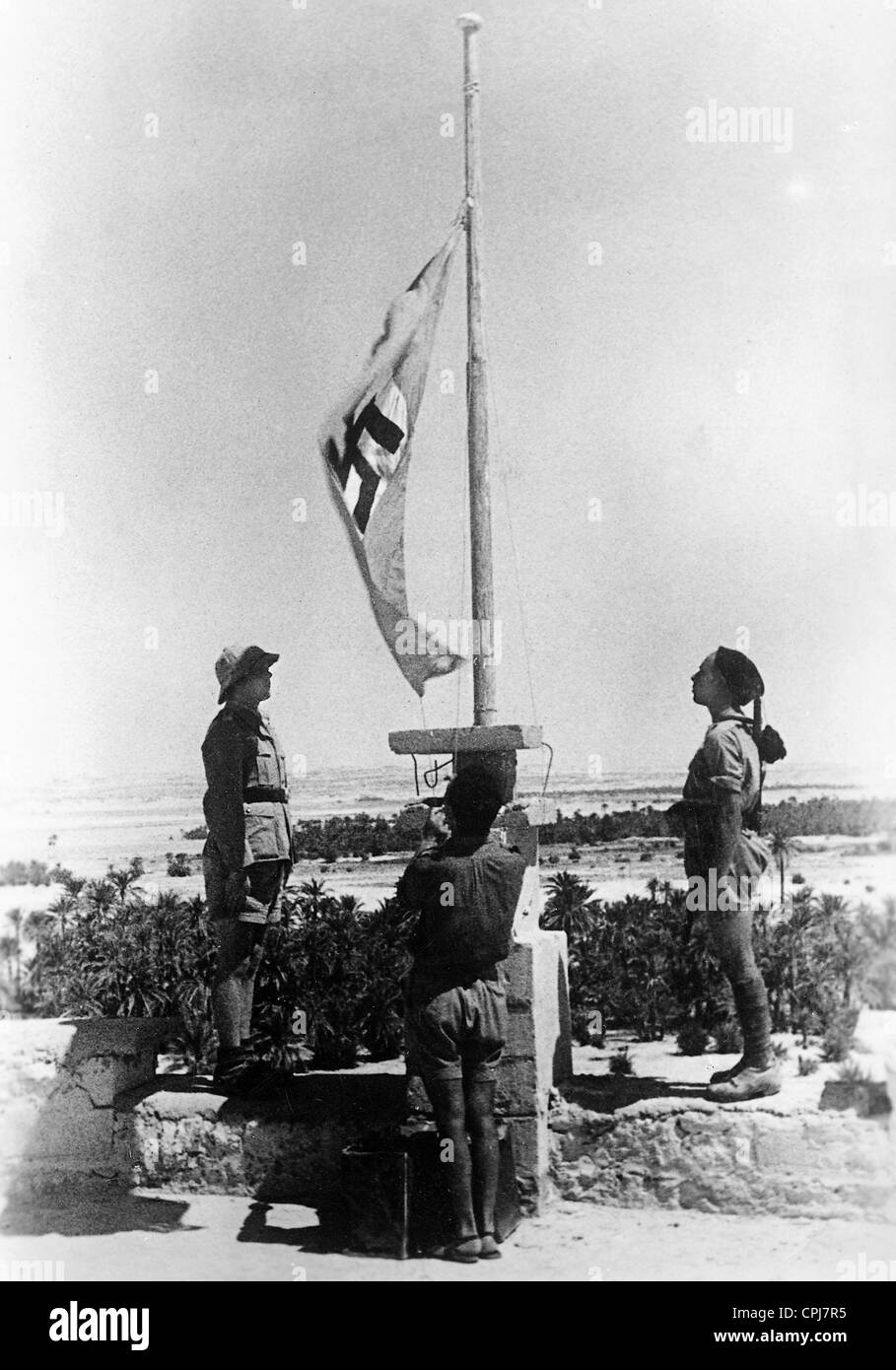 Soldiers of the Axis hoist the flag in Siwa, 1942 Stock Photo Alamy