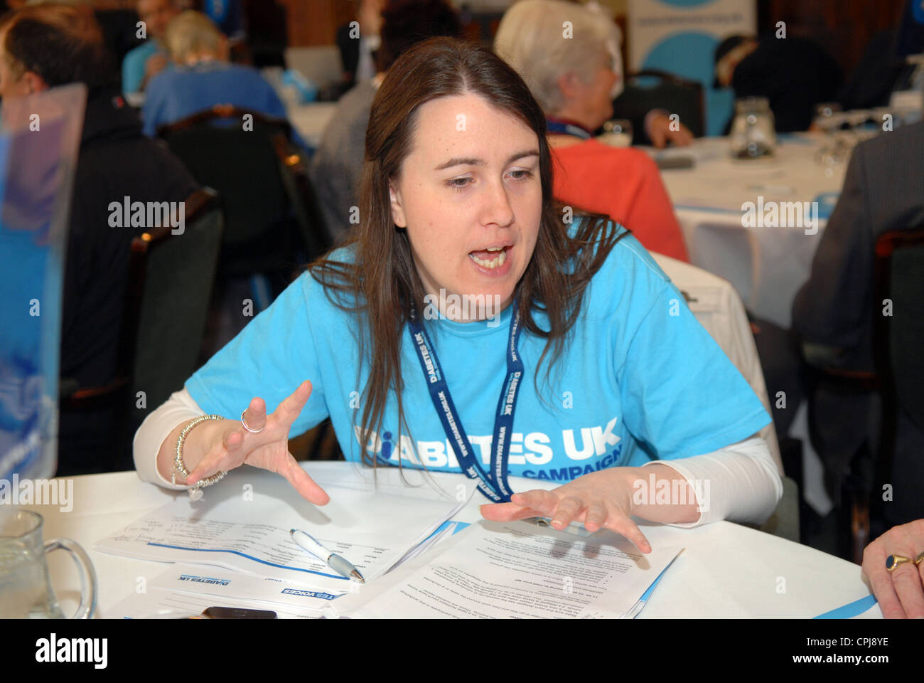 Member of Diabetes UK charity staff talking at a awareness day for