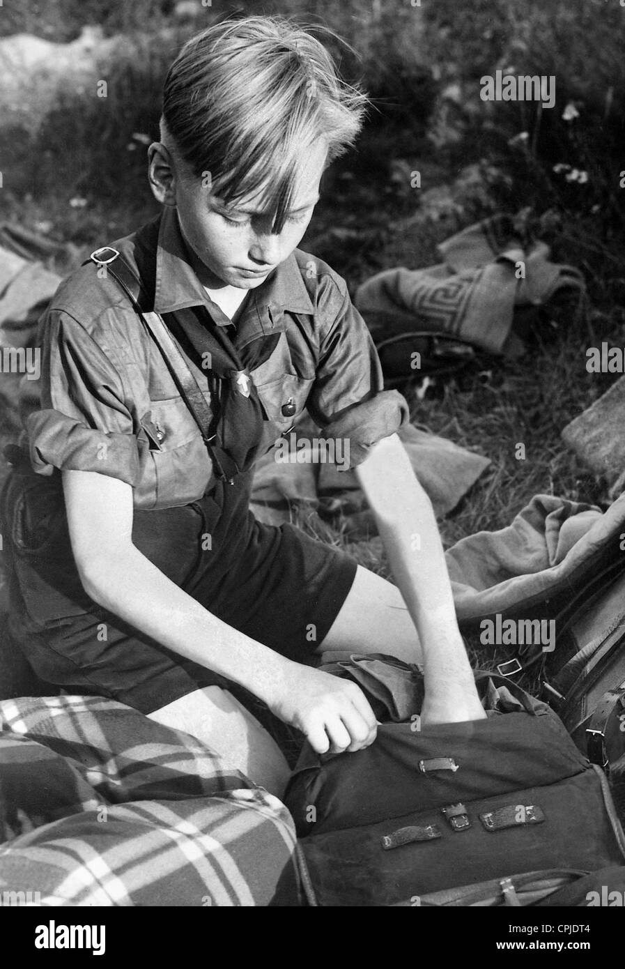 Pimpf of the German Jungvolks (young people) packs his kit bag, 1935 Stock Photo