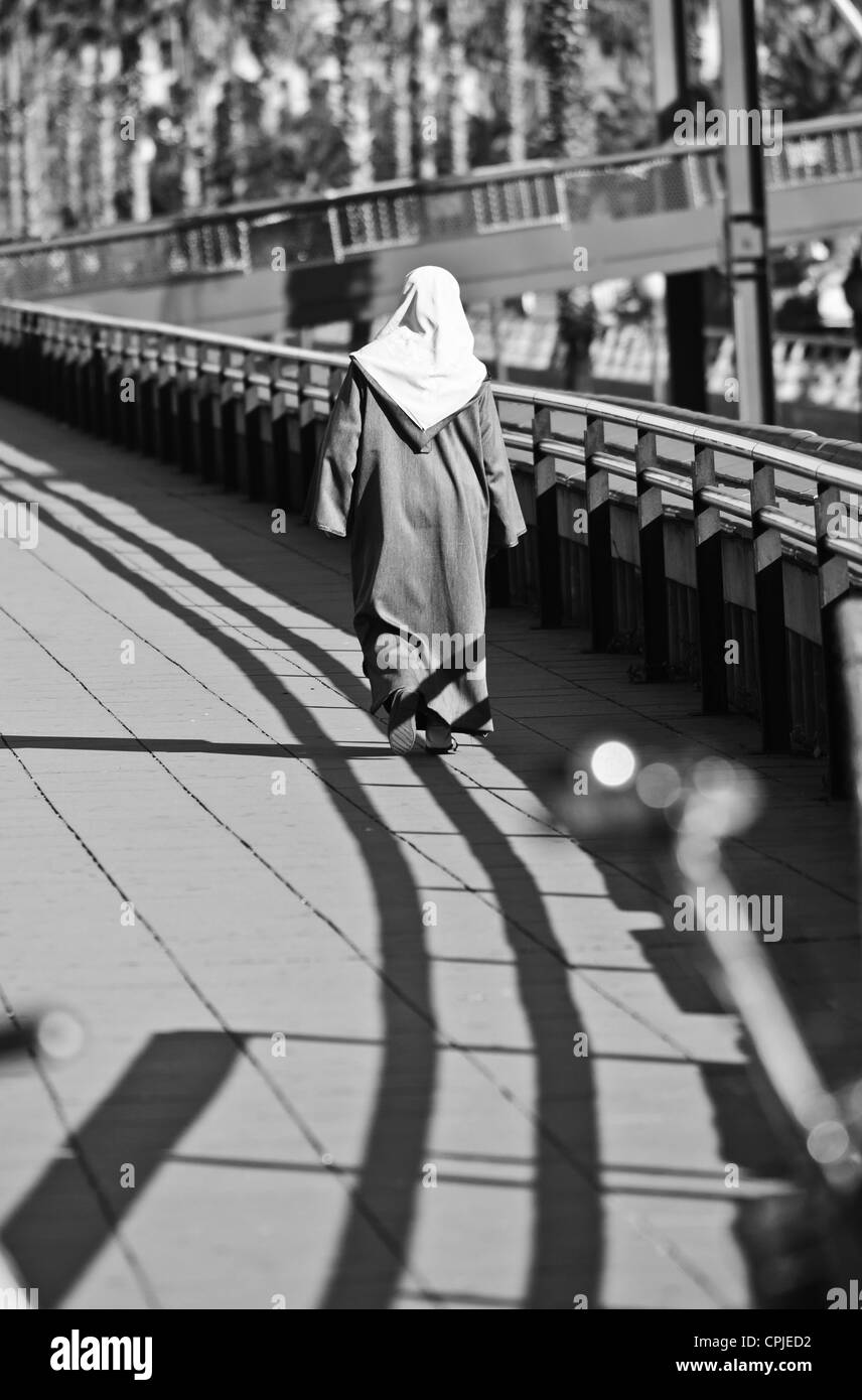 Arab woman wearing hijab walking hi-res stock photography and images ...