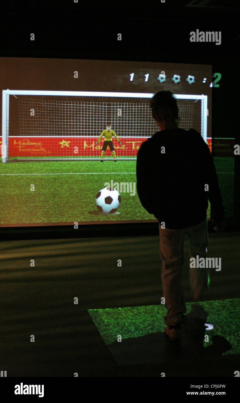 A boy playing an interactive computer football game, Berlin, Germany Stock Photo