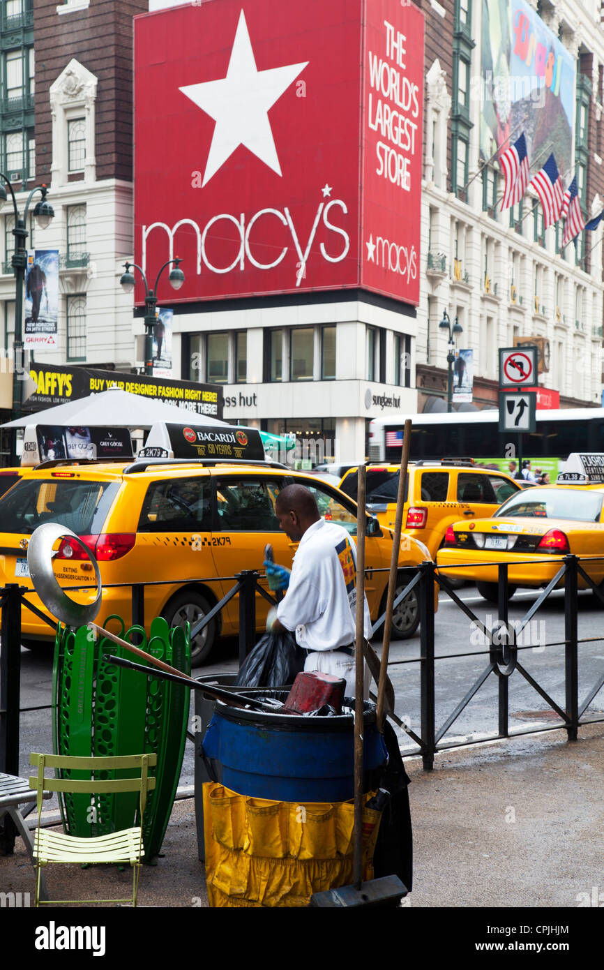 New York City worker emptying bins outside Macy's superstore on