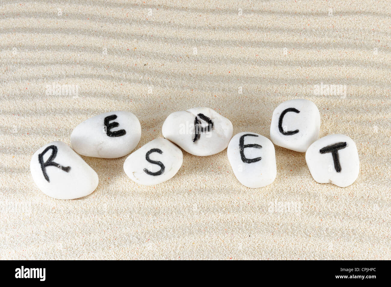 Respect word on group of stones with sand as background Stock Photo