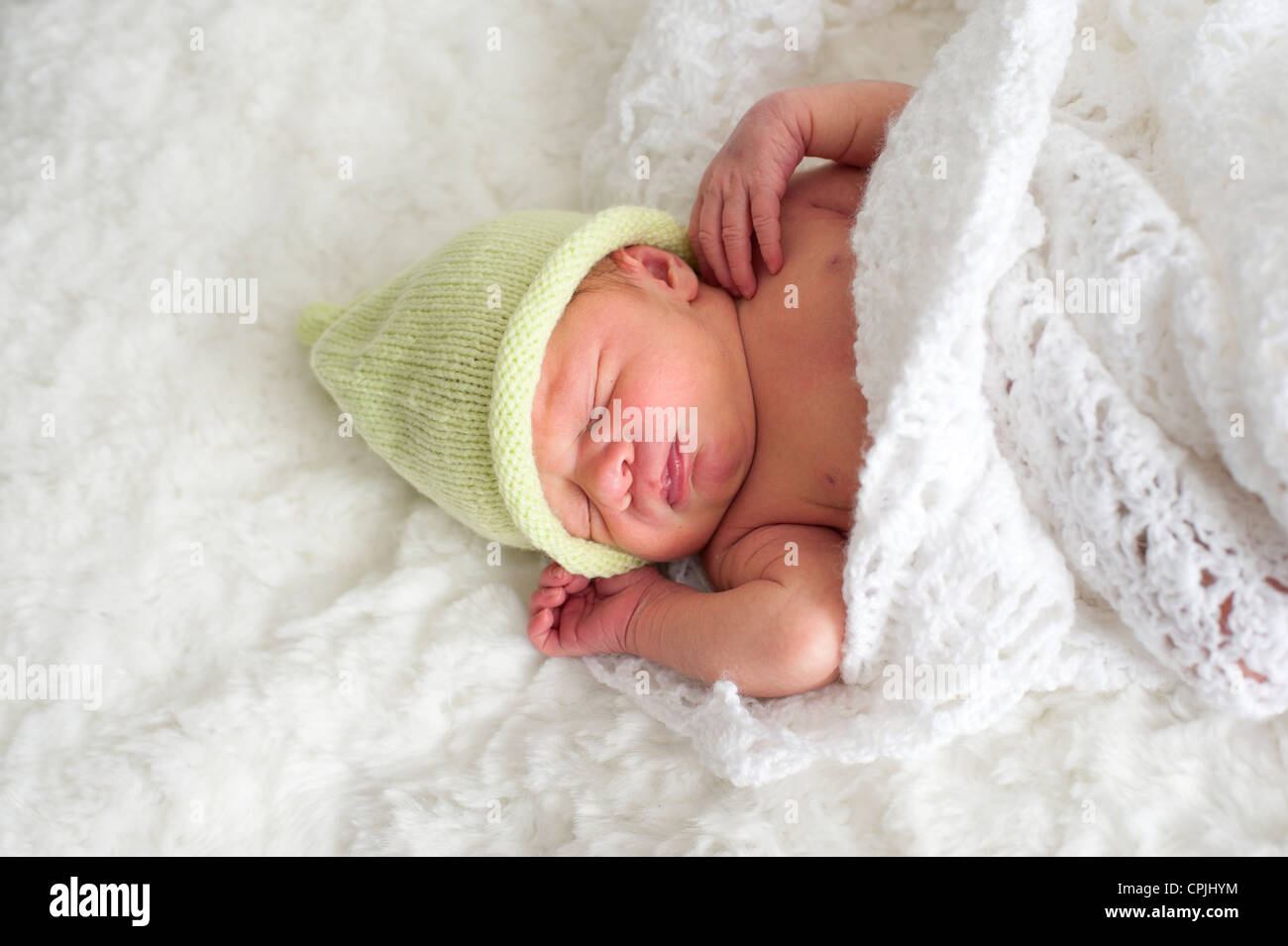 sleeping newborn baby with green hat Stock Photo Alamy