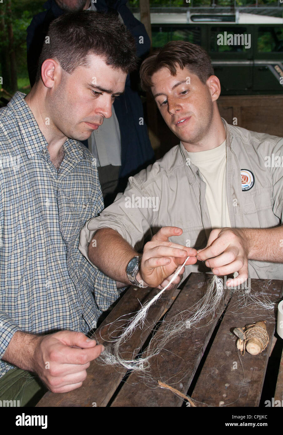 Teaching rope making at a bushcraft meet, Wales, UK Stock Photo