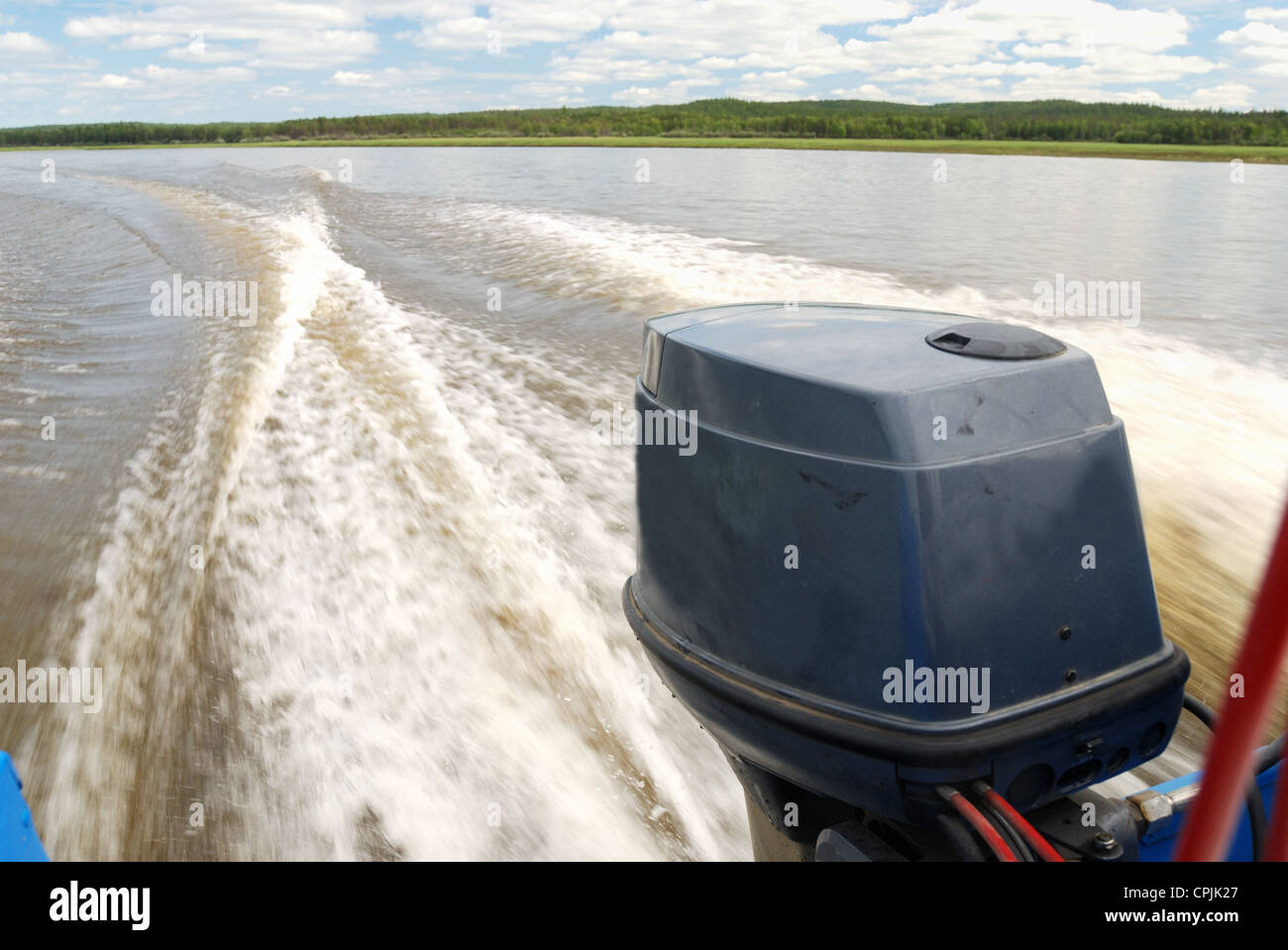 outboard motor boat on the river and wake Stock Photo