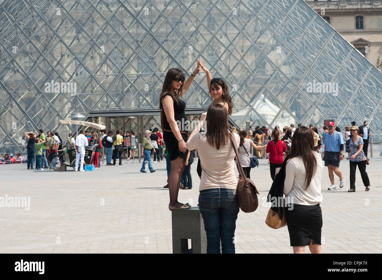 Paris, France - Tourists have picture taken of themselves in front of the Louvre museum Stock Photo