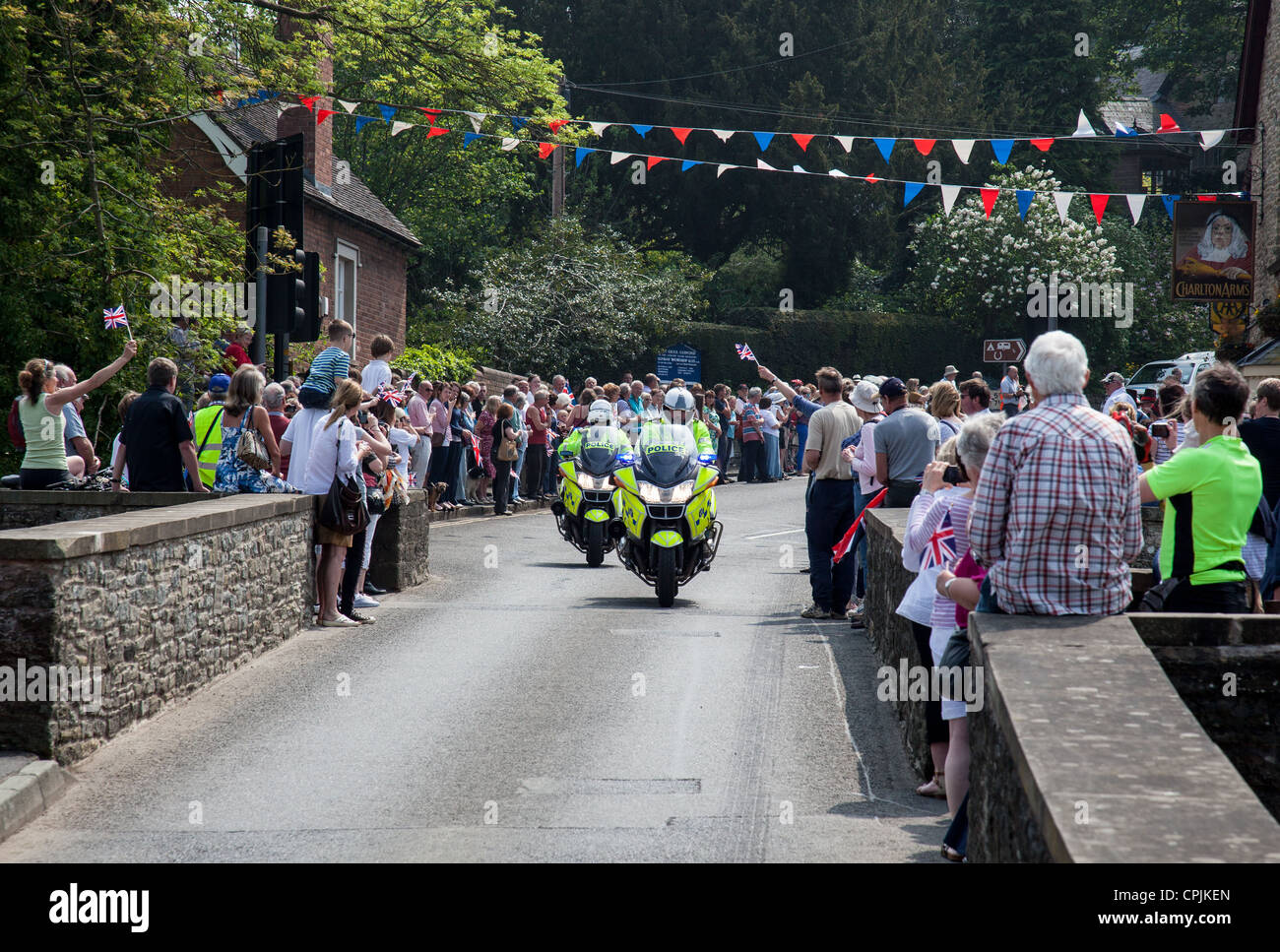 Police motorcycle outriders, part of the London 2012 Olympic Torch Relay, approaching Ludford Bridge, Ludlow, Shropshire Stock Photo