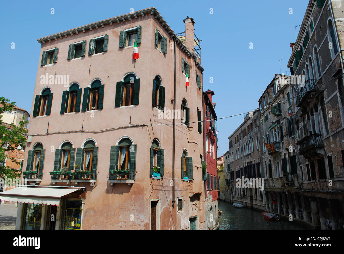 Canal with ancient houses standing in water in Venice, Italy Stock