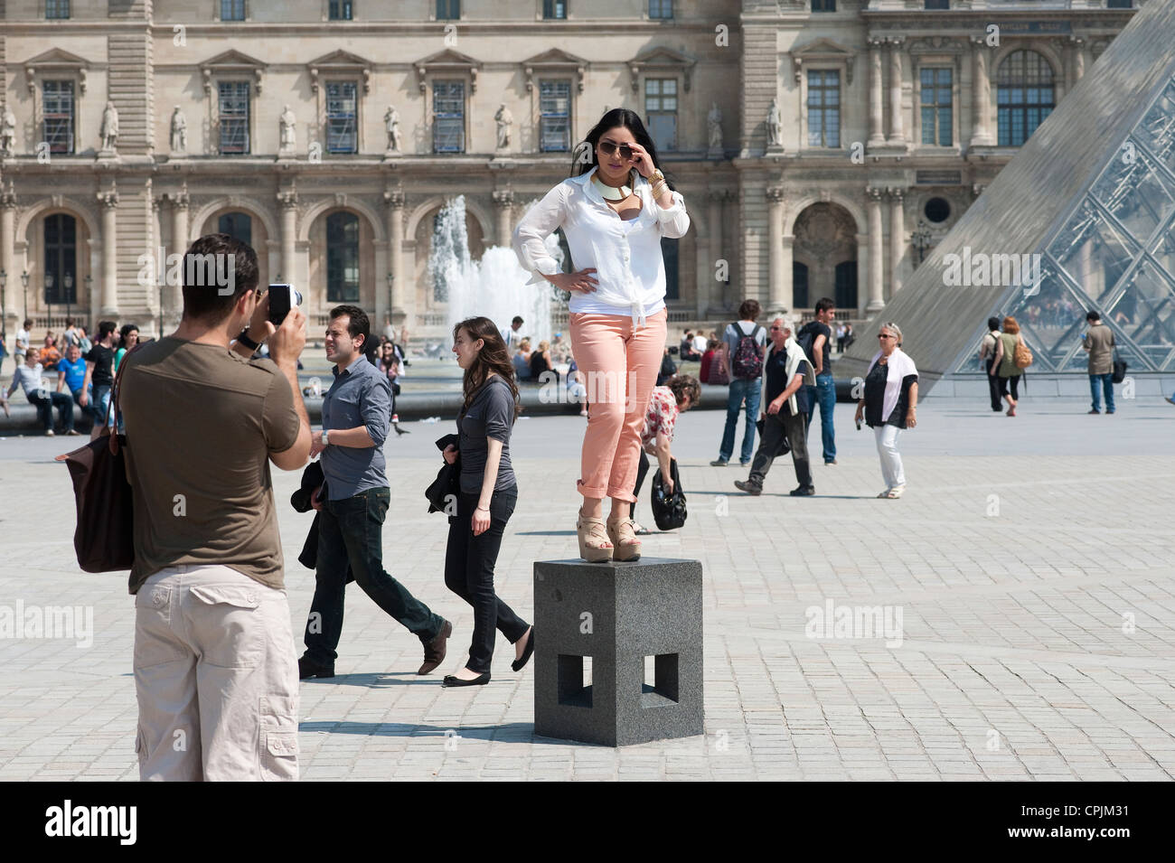 Paris, France - A  female tourist  posing in front of the Louvre museum. Stock Photo