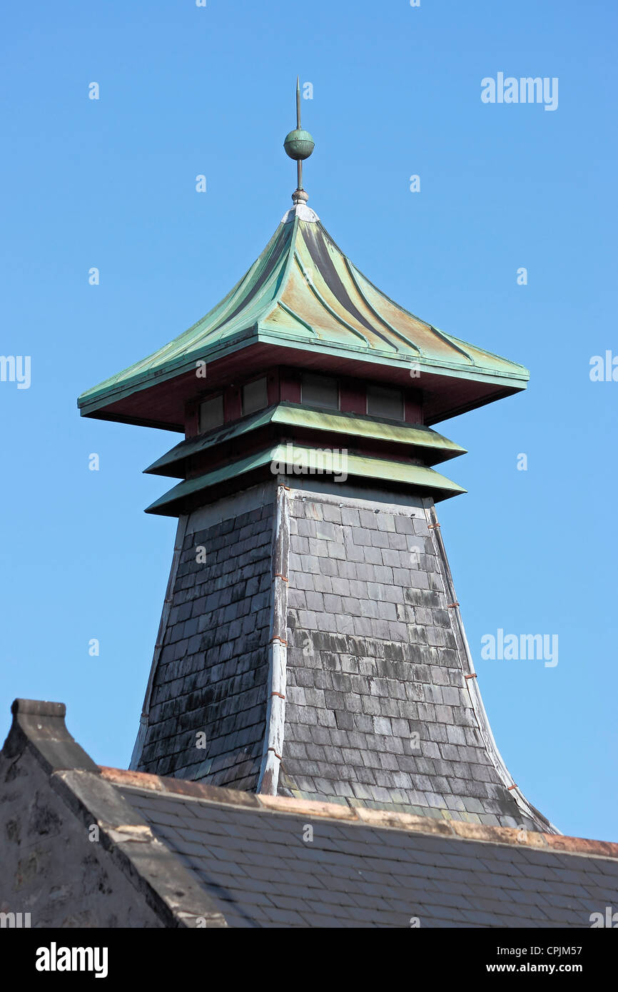 Destillery pagoda roof vent with lightning conductor against clear blue sky Stock Photo