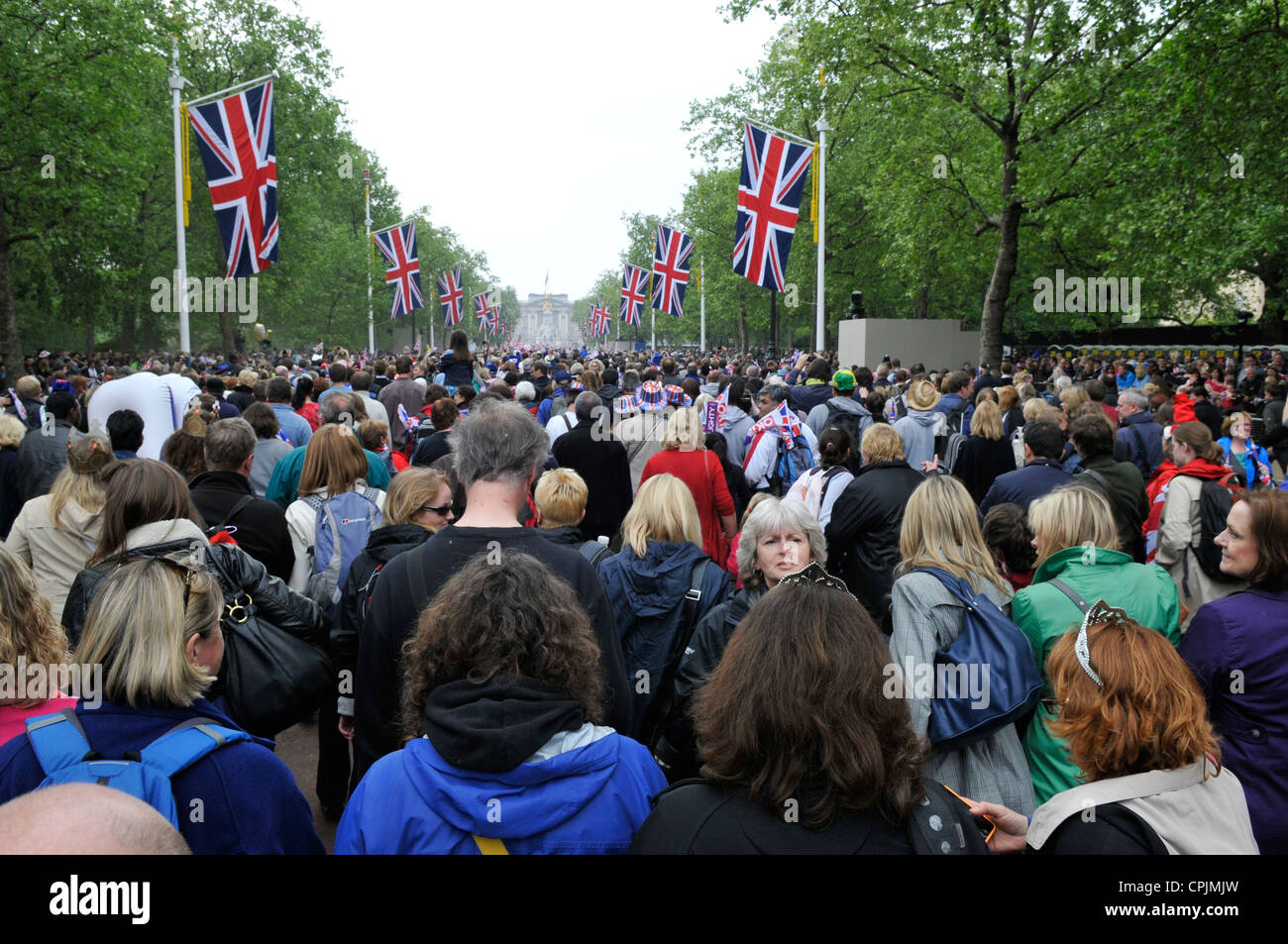 Crowds walking down The Mall towards Buckingham Palace after the wedding of Prince William and Kate Middleton. Stock Photo