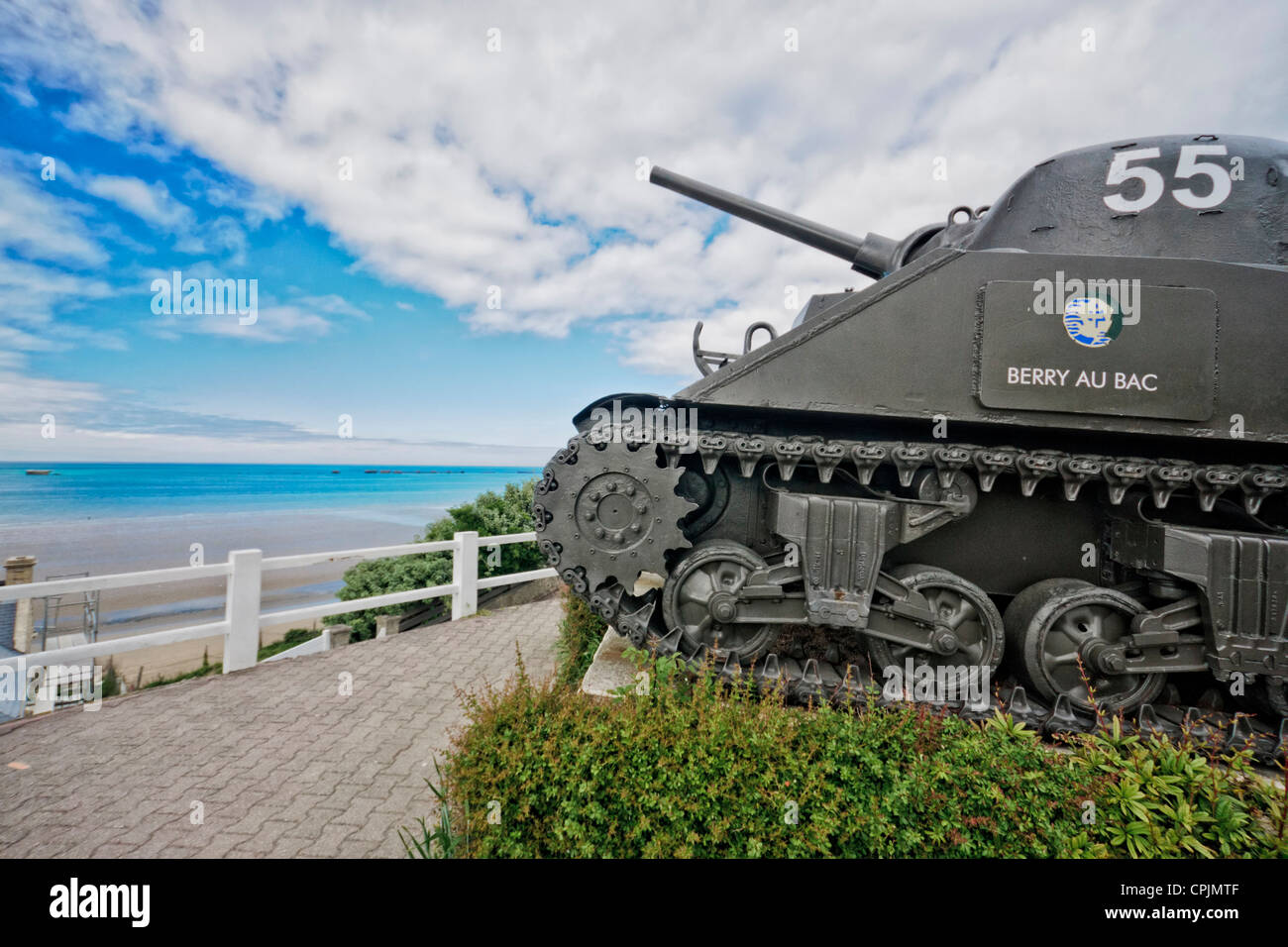 Arromanche-les-Baines,normandy. Canadian Sherman tank overlooks the beach and the remnants of the artificial 'Mulberry'  harbor. Stock Photo